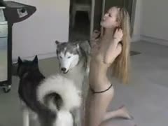 This 18-year-old newbie flaunts her little figure while wanking at two dogs.